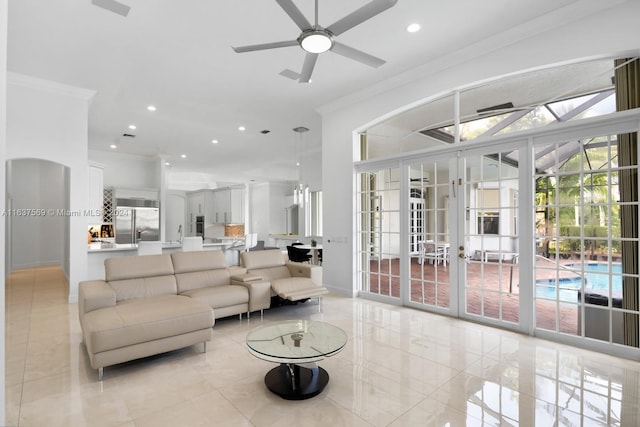 tiled living room featuring french doors, ceiling fan, and ornamental molding