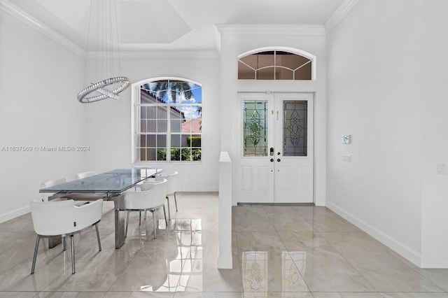 tiled entryway featuring a high ceiling, french doors, and crown molding