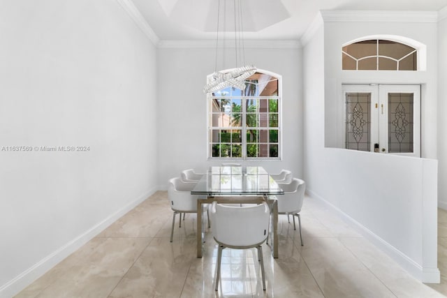 dining room featuring baseboards, light tile patterned flooring, and crown molding