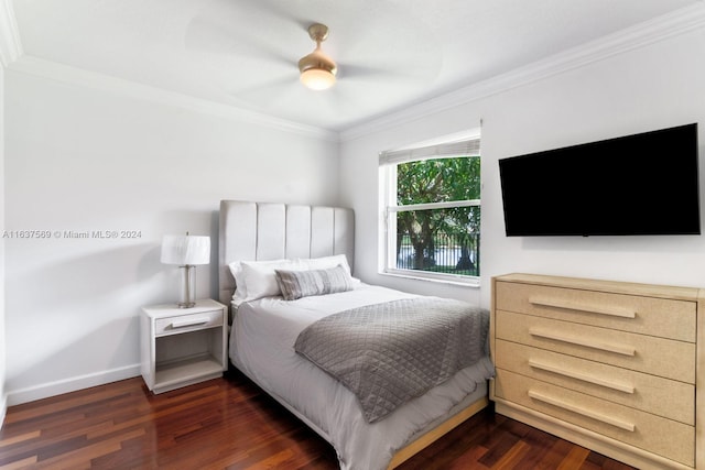 bedroom featuring ornamental molding, dark wood-style flooring, a ceiling fan, and baseboards