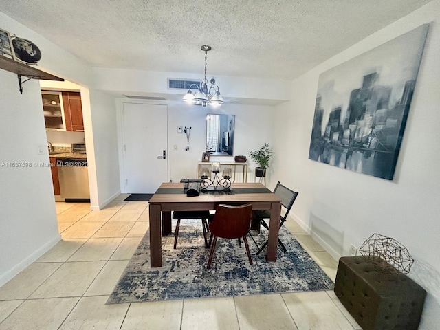3300 NE 191st St Unit 515, Aventura, FL 33180 - dining area with a textured ceiling, a chandelier, and light tile patterned flooring