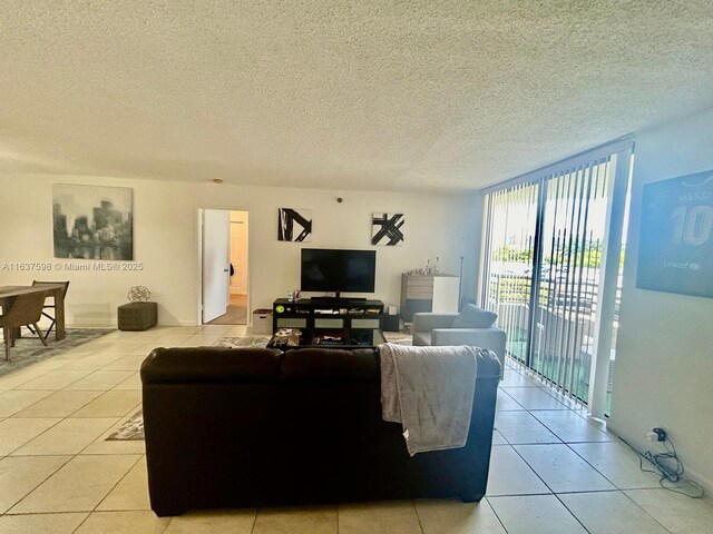 3300 NE 191st St Unit 515, Aventura, FL 33180 - living room featuring light tile patterned floors, a wall of windows, and a textured ceiling