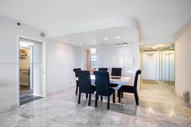 dining room with a textured ceiling