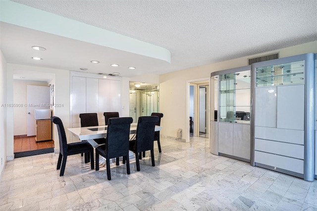 dining room with a textured ceiling