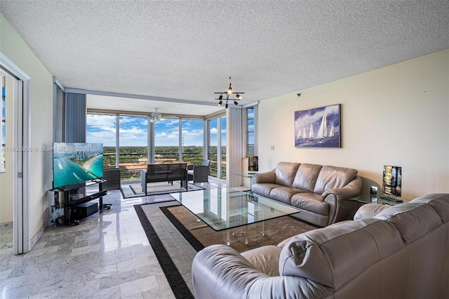 living room with a textured ceiling and floor to ceiling windows