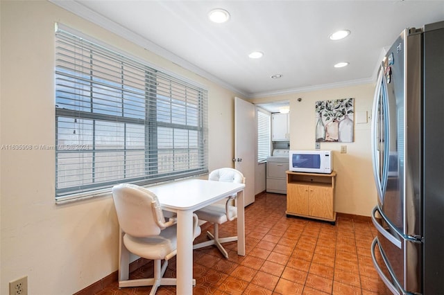 dining room with washer / clothes dryer, light tile patterned flooring, and crown molding