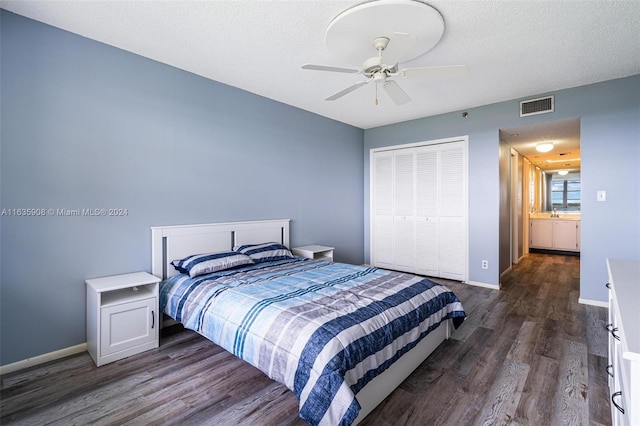 bedroom featuring a closet, ceiling fan, dark hardwood / wood-style floors, and a textured ceiling