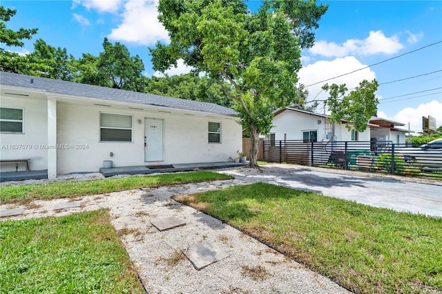 ranch-style home with a front lawn