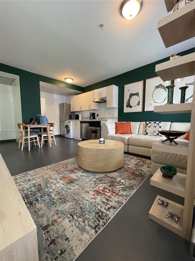 living room featuring washer / dryer