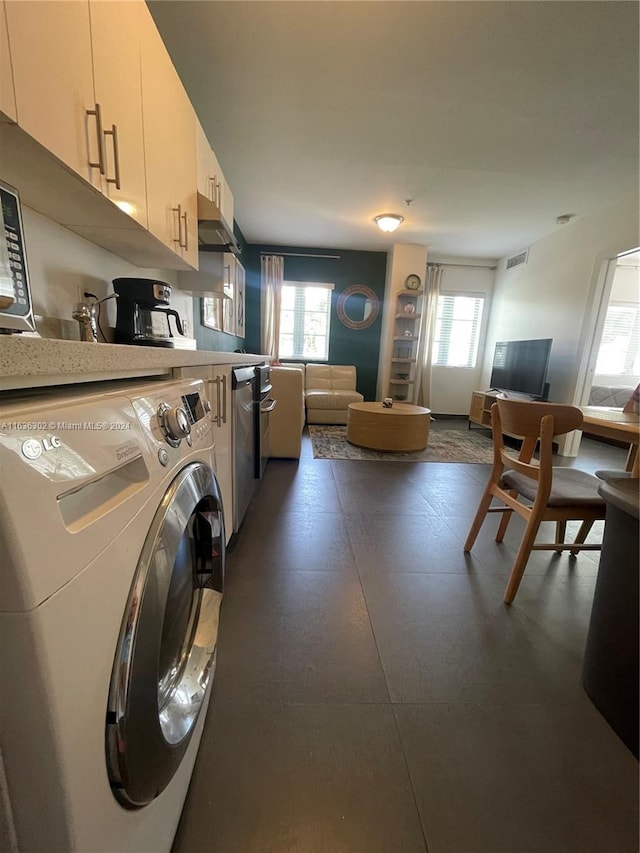 laundry area featuring washer / clothes dryer and plenty of natural light