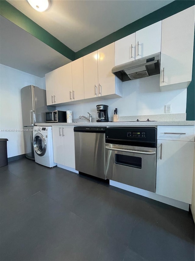 kitchen featuring white cabinetry, stainless steel appliances, and washer / dryer