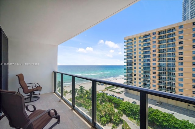 balcony with a water view and a beach view