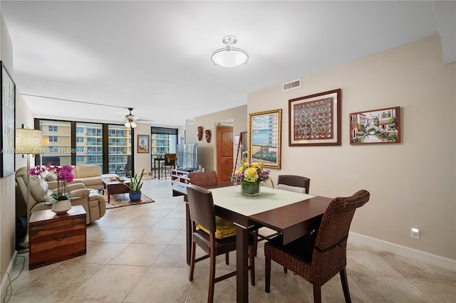 dining space with light tile patterned floors and ceiling fan