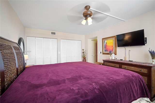 bedroom with multiple closets and ceiling fan