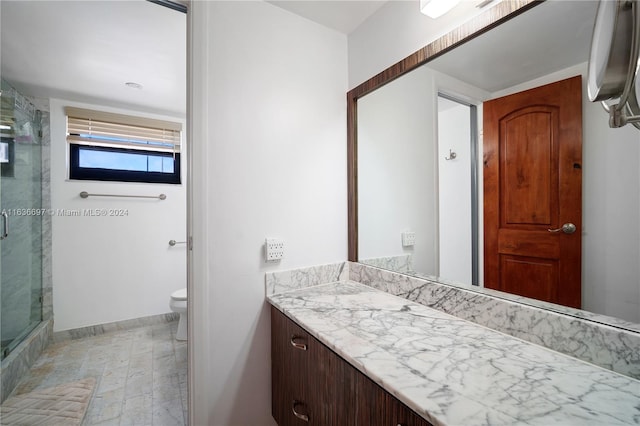 bathroom featuring walk in shower, vanity, and toilet