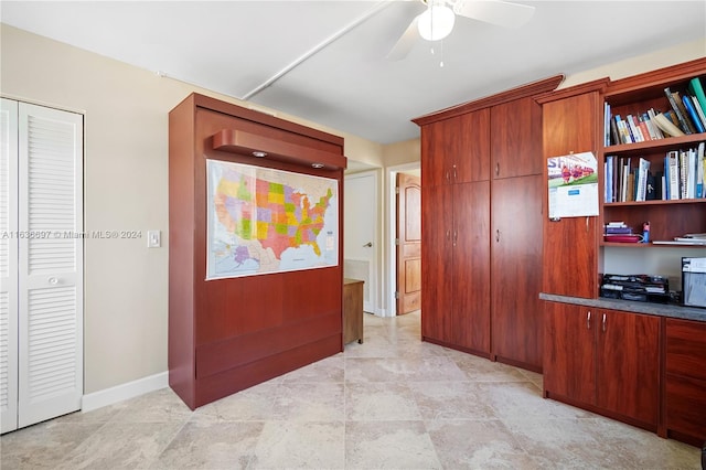 interior space with ceiling fan