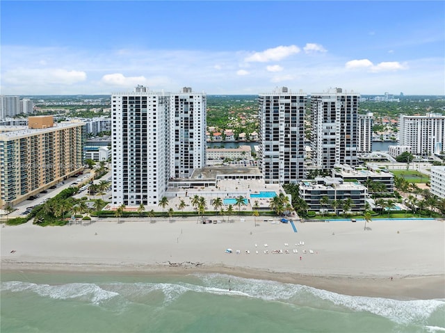 drone / aerial view with a beach view and a water view