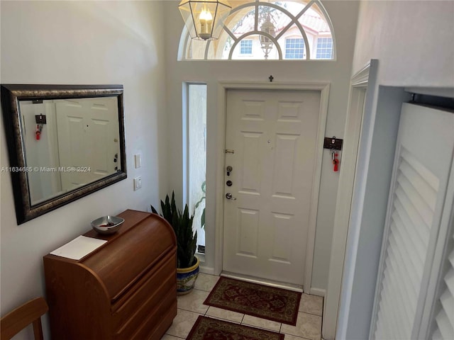 entrance foyer featuring light tile patterned floors and a chandelier
