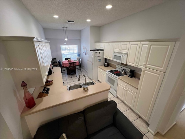 kitchen featuring white appliances, white cabinets, a sink, visible vents, and a textured ceiling