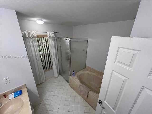 bathroom featuring a stall shower, a garden tub, tile patterned flooring, and vanity
