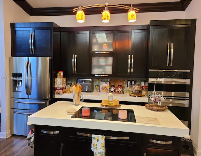 kitchen featuring ornamental molding, appliances with stainless steel finishes, decorative backsplash, and dark hardwood / wood-style floors