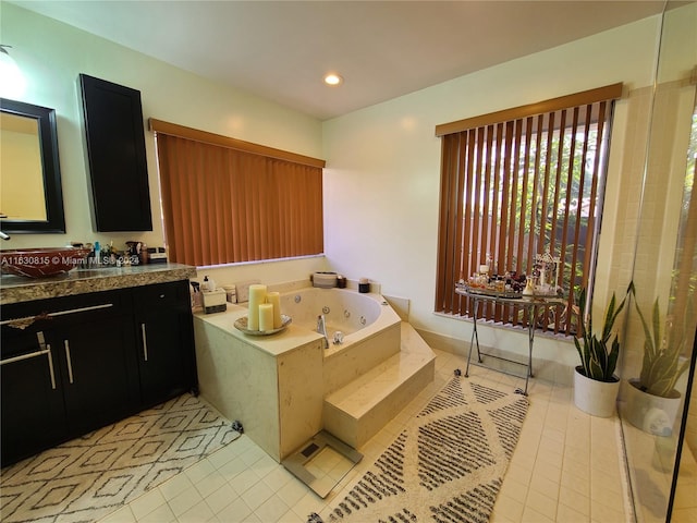 bathroom featuring vanity, tile patterned floors, and a relaxing tiled tub