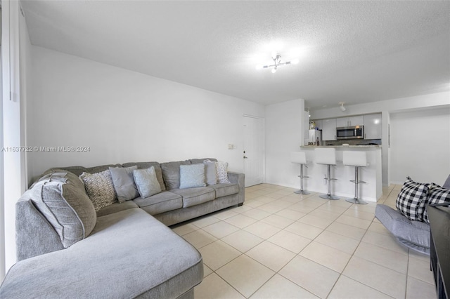 tiled living room with a textured ceiling