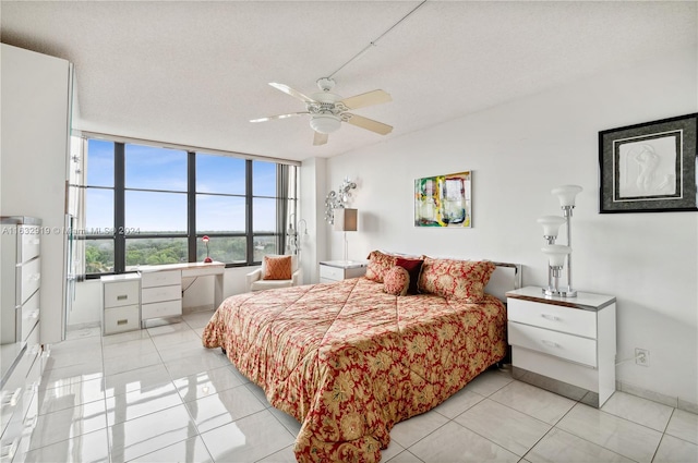 bedroom with floor to ceiling windows, a textured ceiling, light tile patterned floors, and ceiling fan