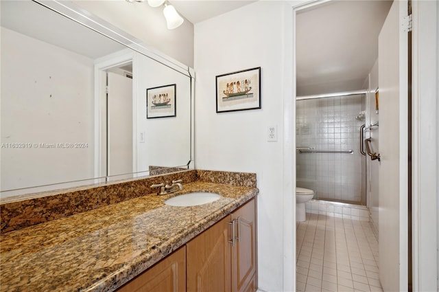 bathroom with vanity, toilet, and tile patterned floors