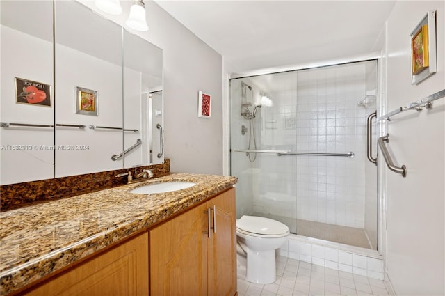 bathroom with tile patterned flooring, a shower with shower door, toilet, and vanity