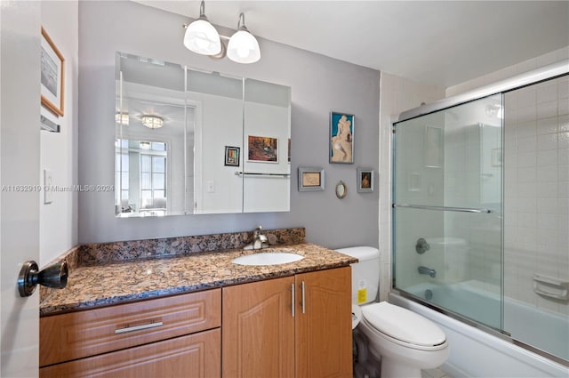 full bathroom with bath / shower combo with glass door, vanity, and toilet