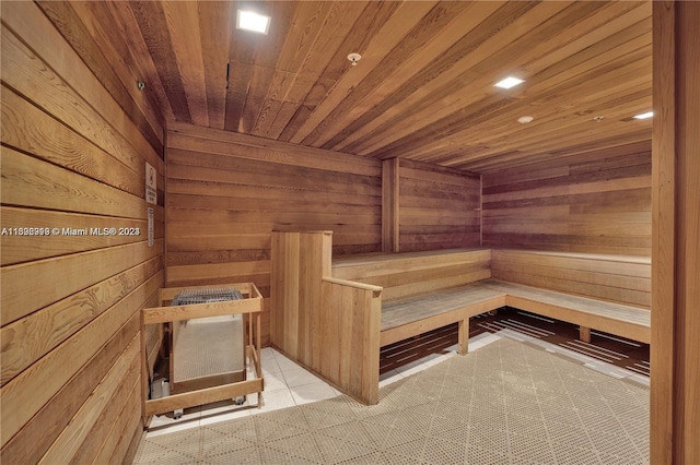 view of sauna with wooden ceiling, wooden walls, and tile patterned floors