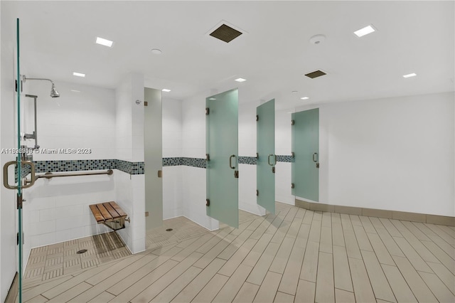 interior space with tile patterned floors and a shower with door