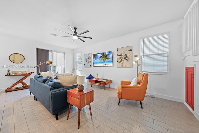 living room featuring light hardwood / wood-style floors and ceiling fan