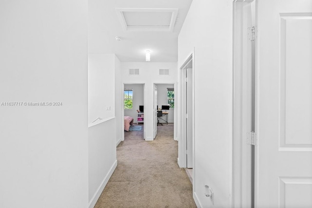 hallway featuring light carpet