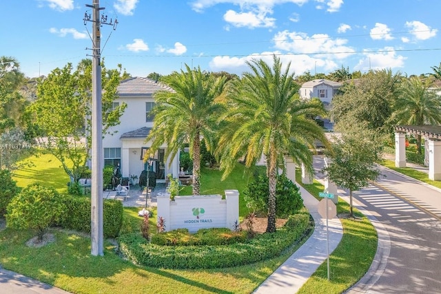 view of property's community with a lawn