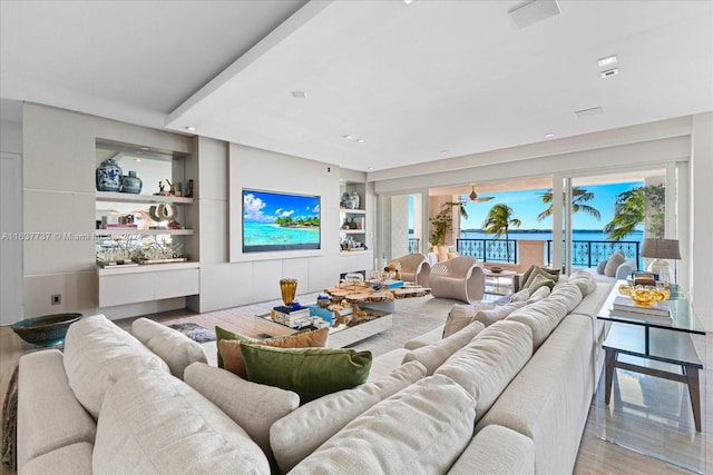 living room with built in features and hardwood / wood-style floors