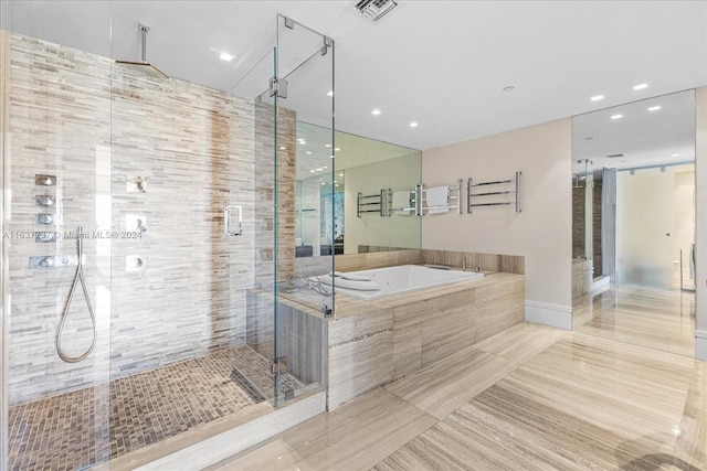 bathroom with shower with separate bathtub and tile patterned floors