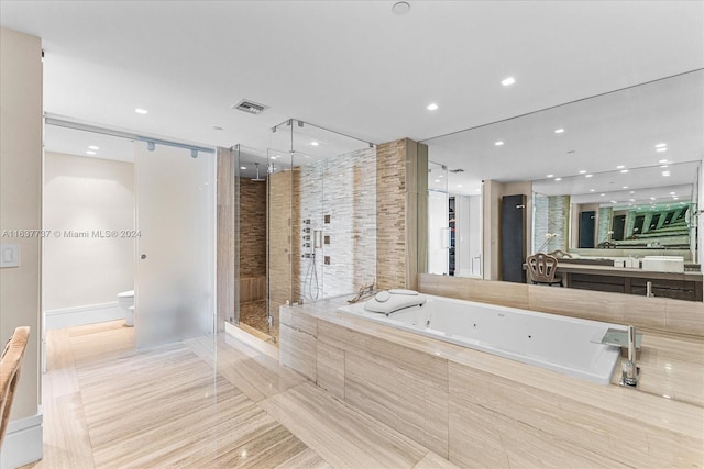 full bathroom featuring independent shower and bath, vanity, tile patterned flooring, and toilet