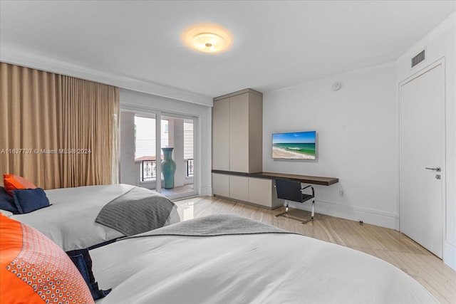 bedroom with access to outside and light hardwood / wood-style floors