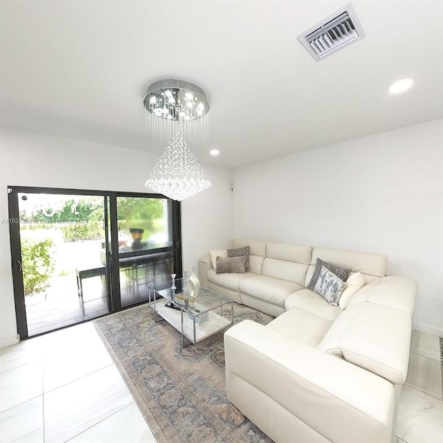 living room with tile patterned floors and an inviting chandelier