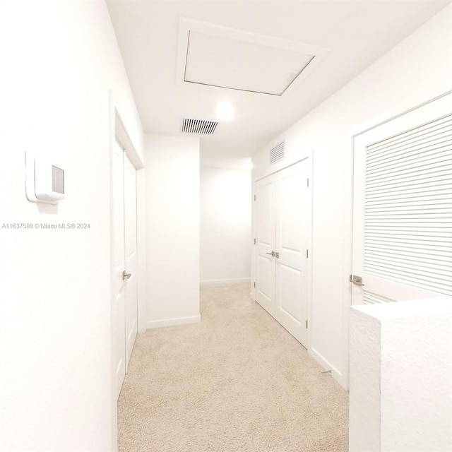 corridor with light colored carpet