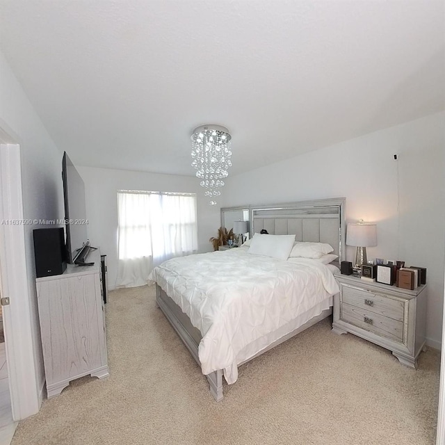 carpeted bedroom with a notable chandelier