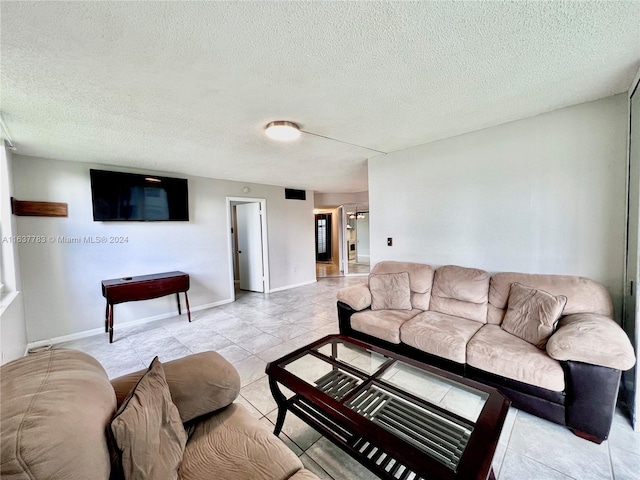 tiled living room with a textured ceiling