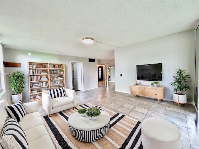 tiled living room with a textured ceiling