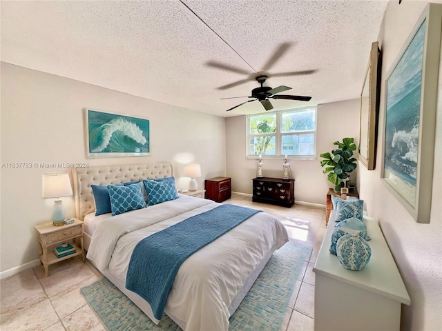 tiled bedroom featuring a textured ceiling and ceiling fan