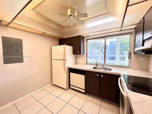 kitchen with tasteful backsplash, sink, dark brown cabinetry, tile countertops, and white appliances