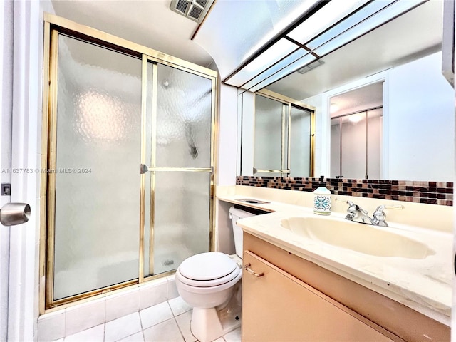 bathroom featuring tile patterned flooring, an enclosed shower, vanity, and toilet