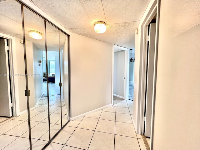 hall featuring light tile patterned flooring