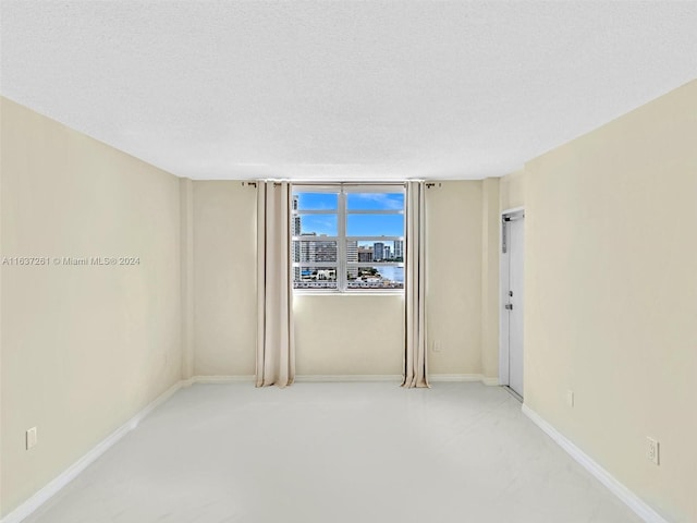 empty room featuring a textured ceiling